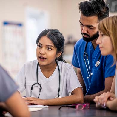 A medical professional explaining something to her team