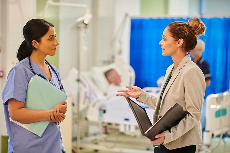 Two female medical professionals having a conversation