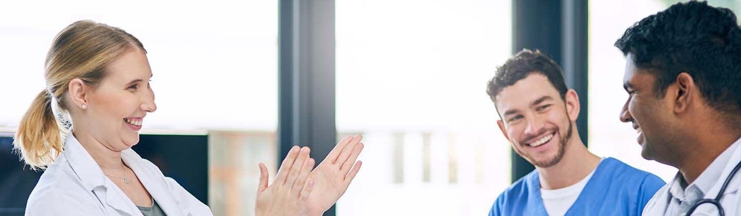 A group of doctors and nurses clapping