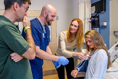 hospital nurse educating parents about care and treatment of their child