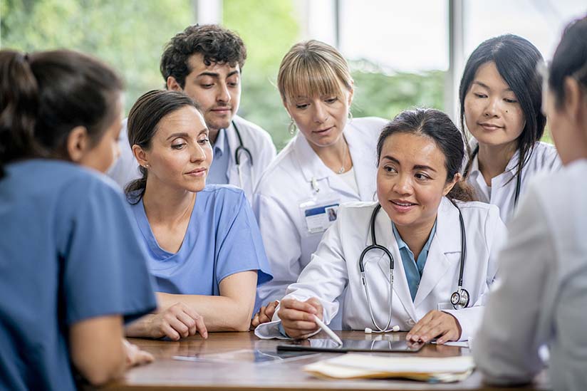 A medical professional explaining something to her team.