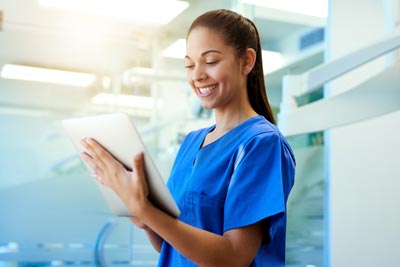 Nurse holding a tablet.